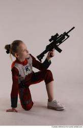 DENISA KNEELING POSE WITH GUN